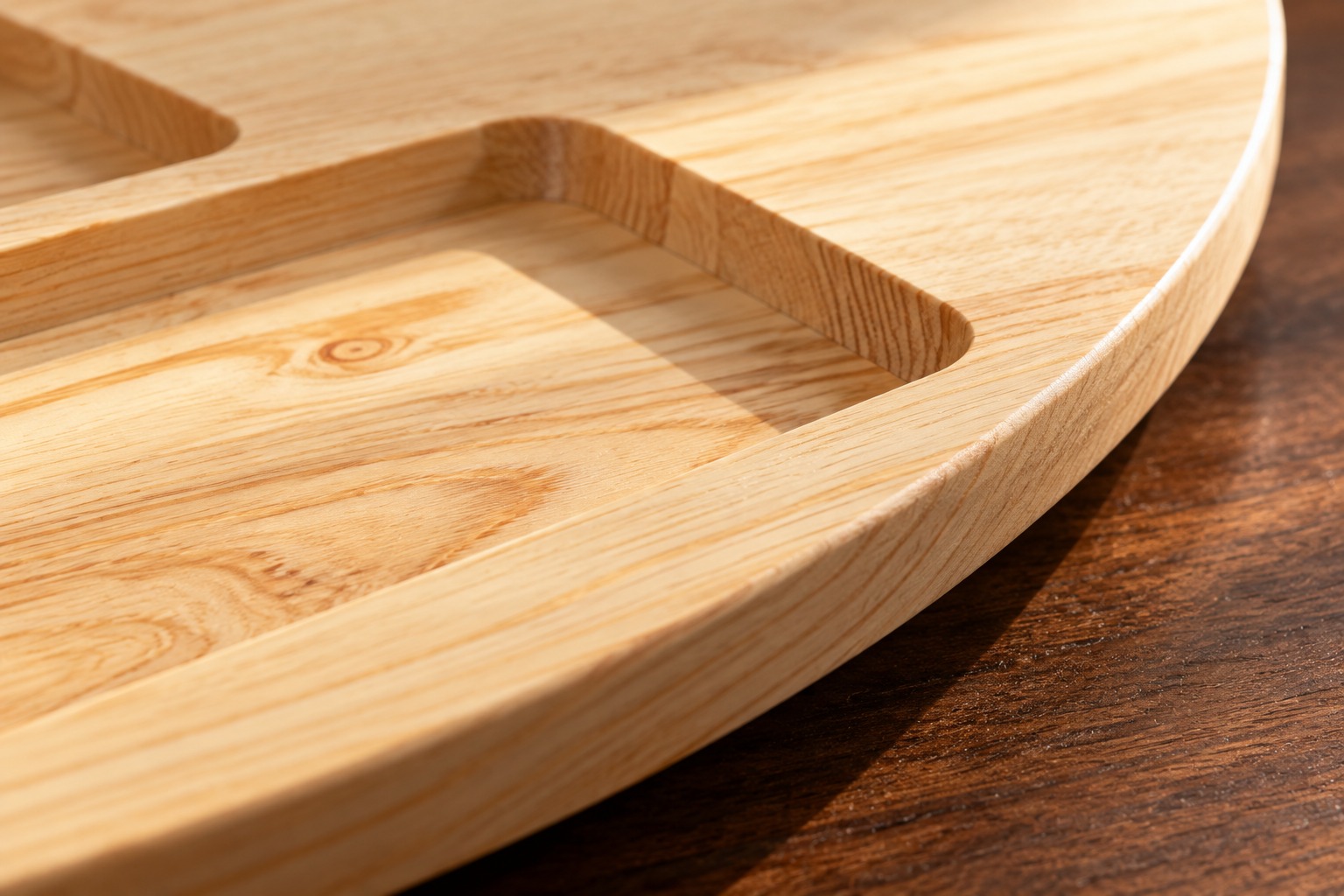 Close-up of natural pine grain, a rounded tray edge and a recessed sorting groove